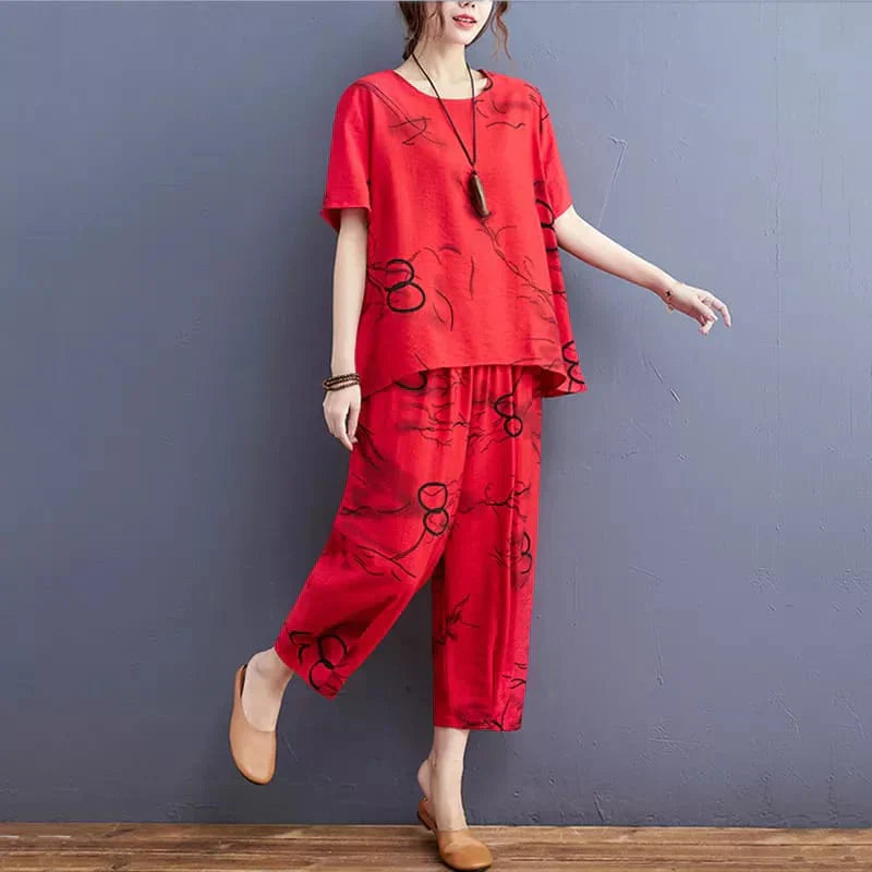 Person wearing a red outfit with black patterns against a gray wall.