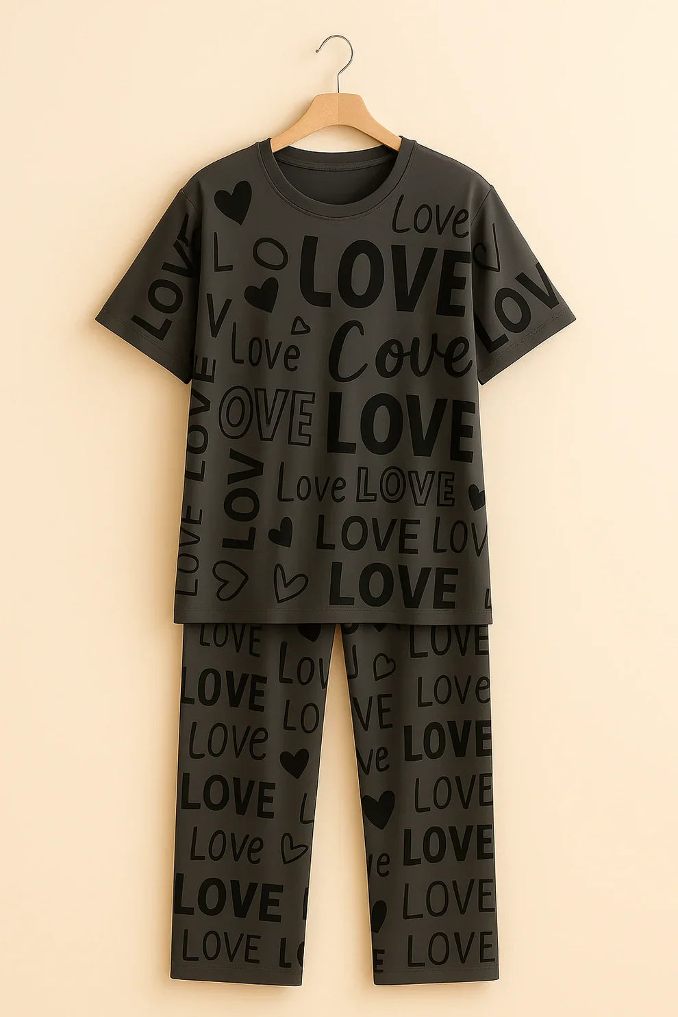 Black pajama set with 'LOVE' print on a beige background