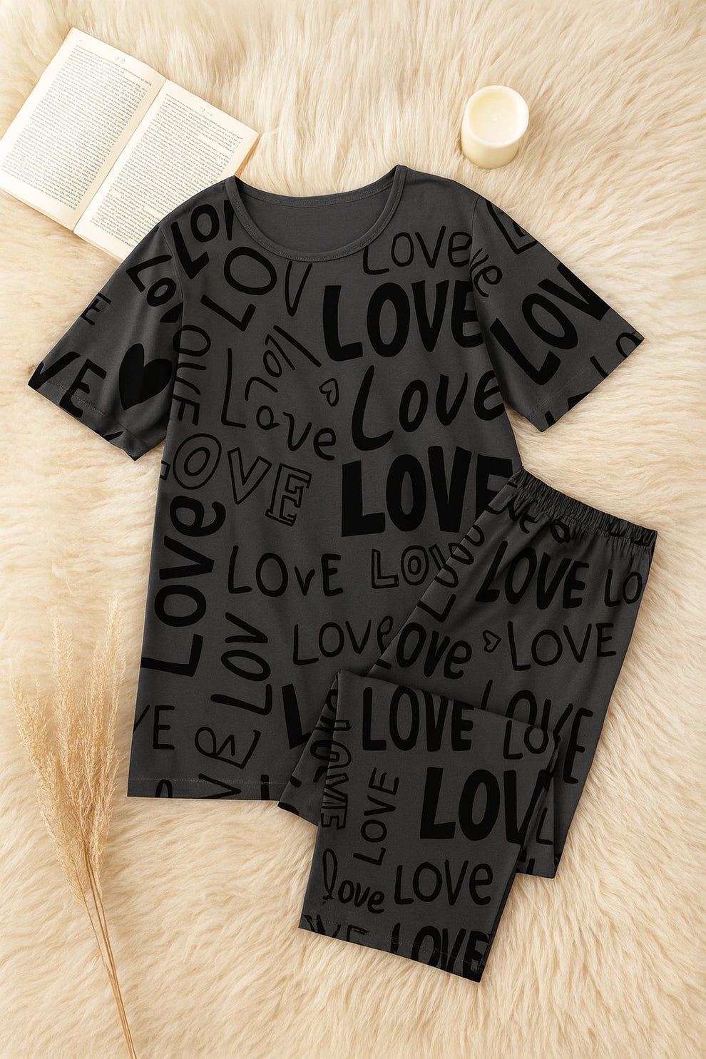Black pajama set with 'LOVE' print on a textured surface