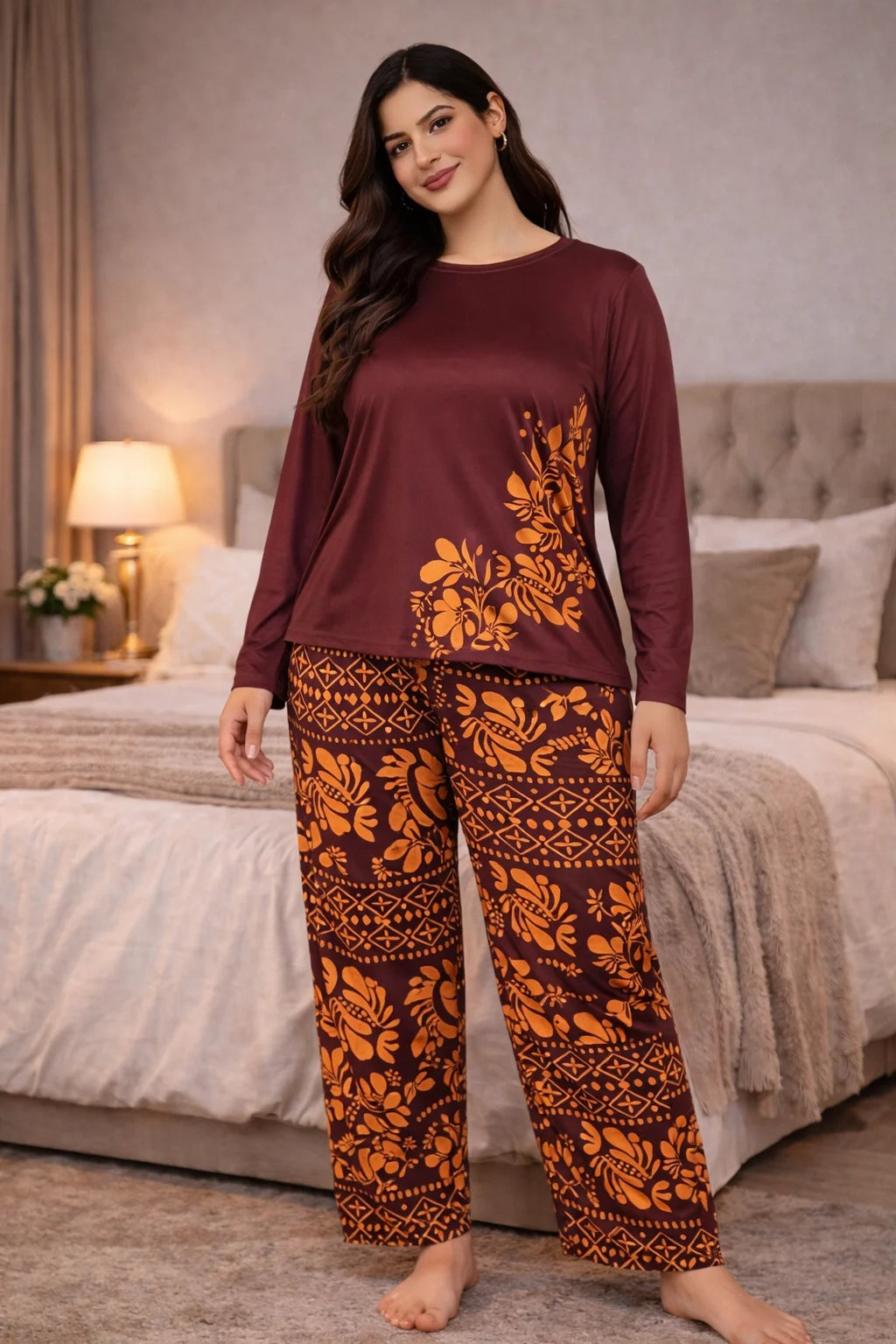 Woman wearing a maroon top and patterned pants in a bedroom setting