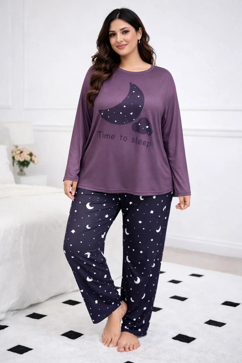 Woman wearing a purple top and navy pants with moon and star patterns on a white background.