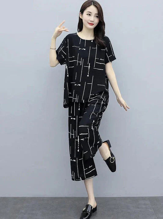 Woman wearing a black and white patterned outfit on a gray background