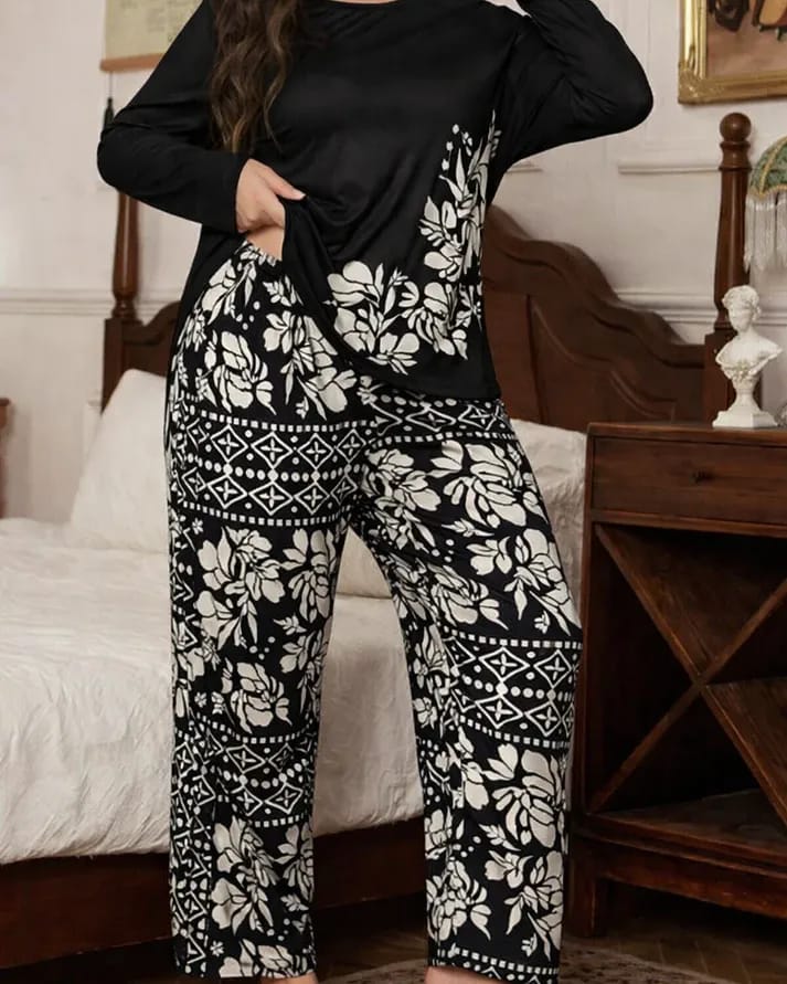 Person wearing a black and white patterned outfit in a bedroom setting