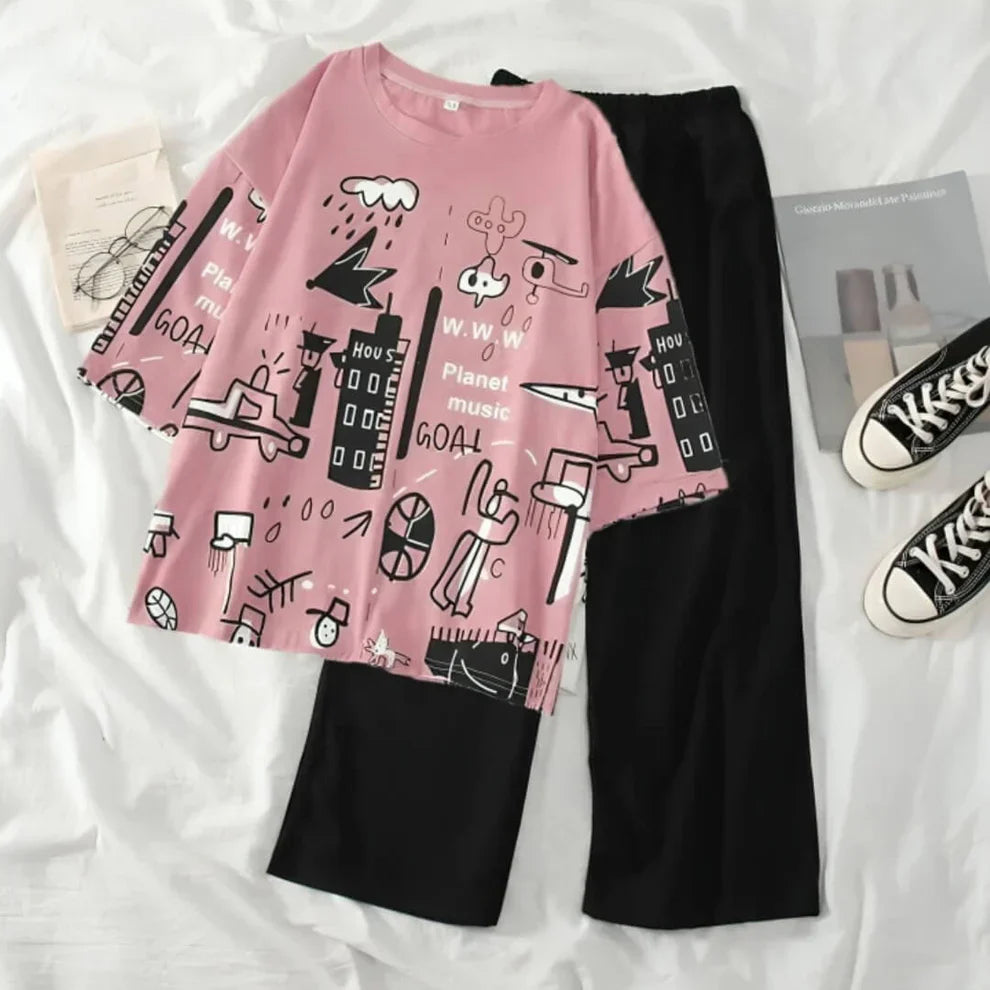 Pink t-shirt with black graphics and black pants on a white surface