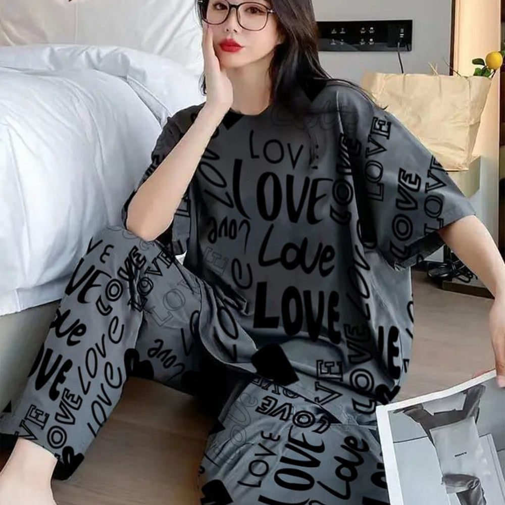 Person wearing a gray 'LOVE' printed outfit sitting on a couch.
